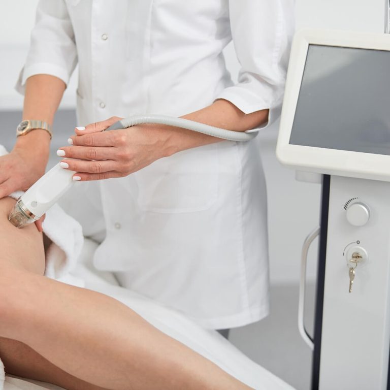 woman and doctor showing lase hair removal procedure on legs